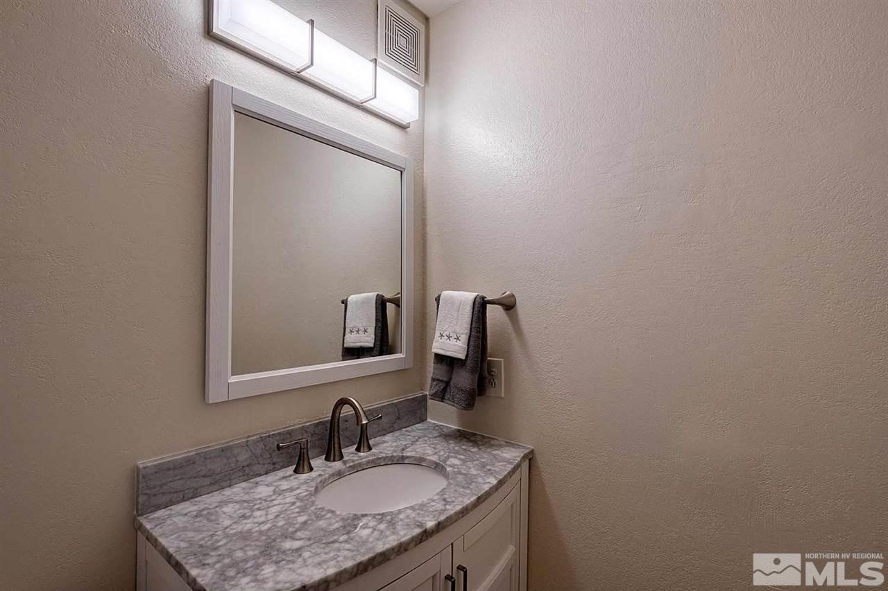 3915 Clear Acre Lane, Unit 149 Reno, NV 89512 - Photo 10 of 21 a bathroom with a sink vanity and a mirror