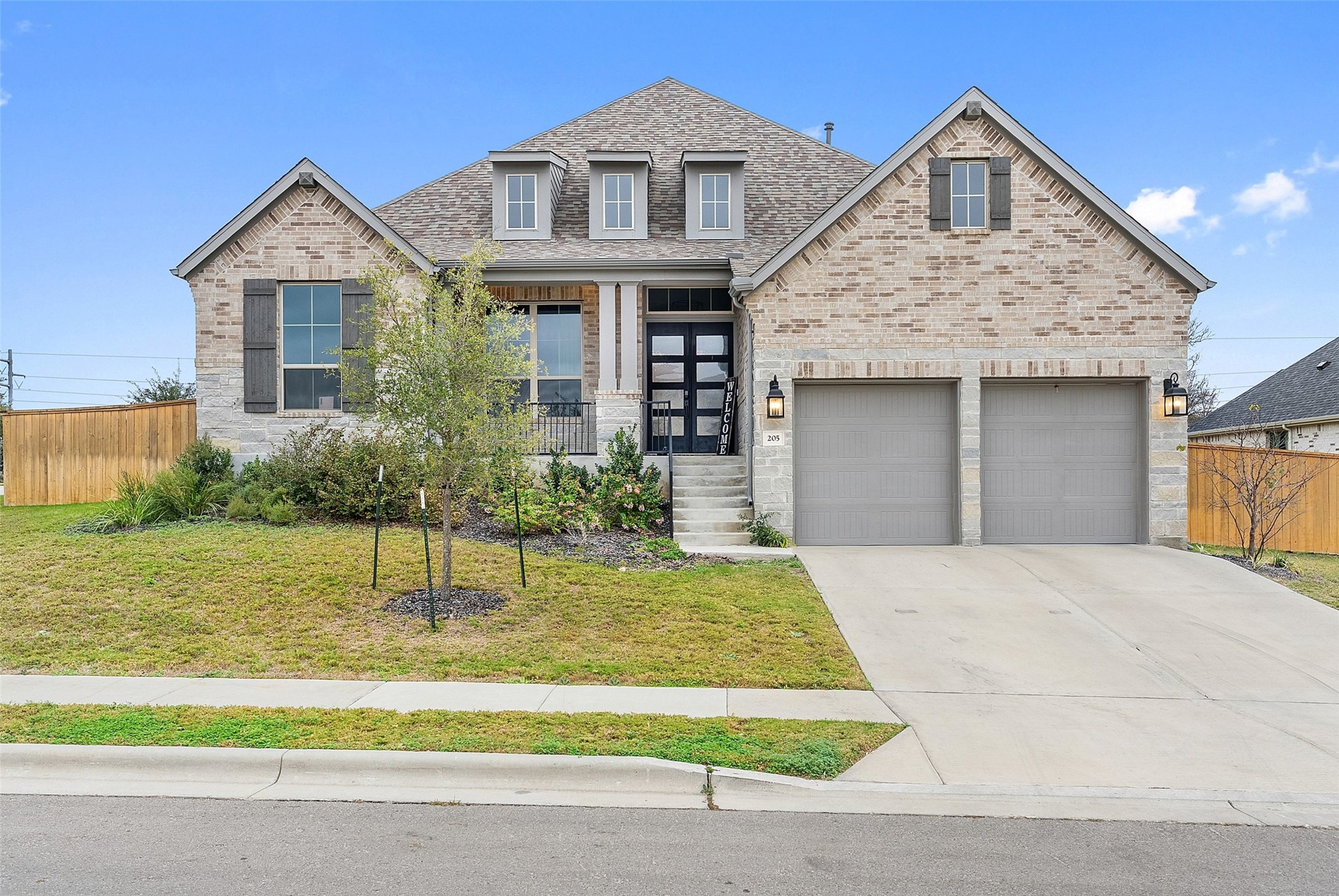 a front view of a house with a yard and garage