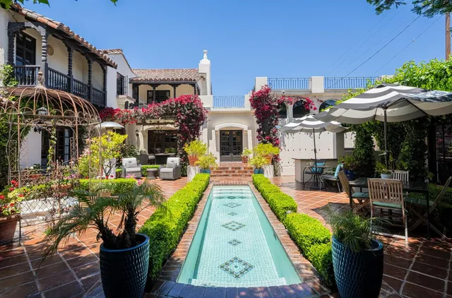 a aerial view of a house with a yard and potted plants