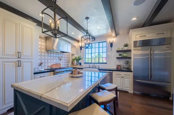 a view of a backyard with table and chairs potted plants with wooden floor