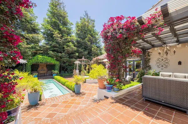 a aerial view of a house with a yard and potted plants