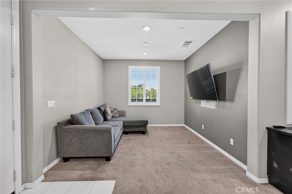 23347 Crystal Way Wildomar, CA 92595 - Photo 37 of 109 a living room with furniture and a flat screen tv