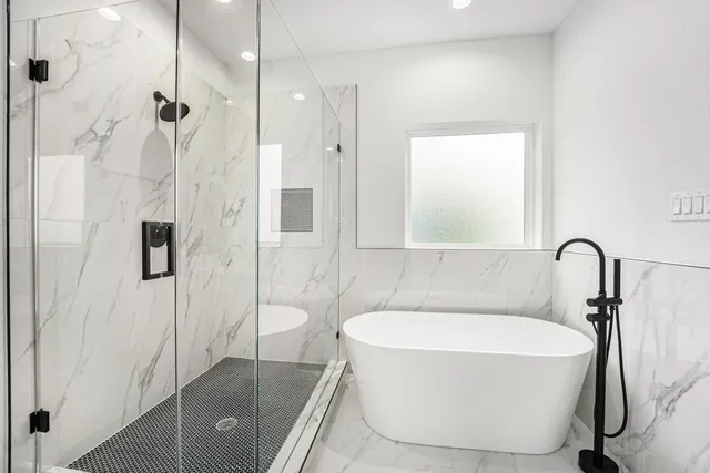 a bathroom with a bathtub and shower