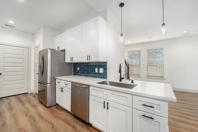 a kitchen with a sink stove and refrigerator
