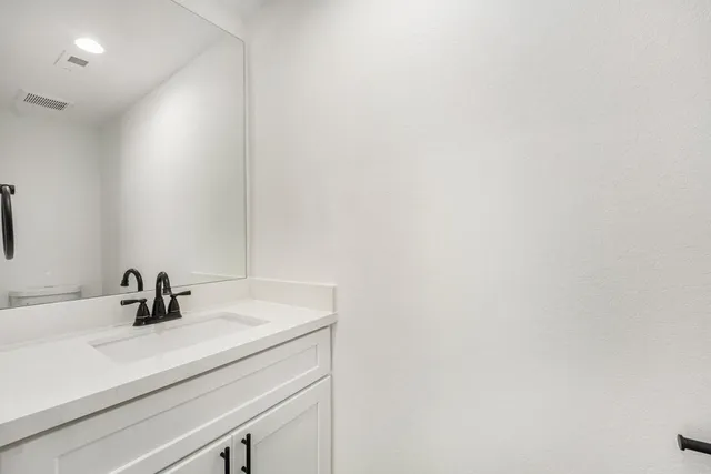 a bathroom with a sink and mirror