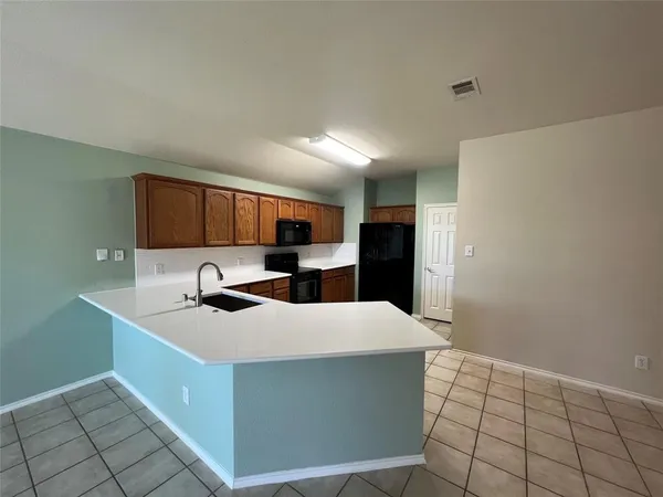 a kitchen with stainless steel appliances a sink stove and refrigerator