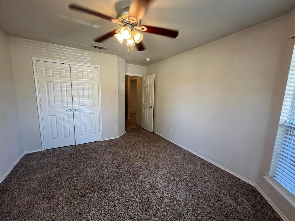 717 Mahogany Drive Anna, TX 75409 - Photo 6 of 11 en empty room with windows and fan