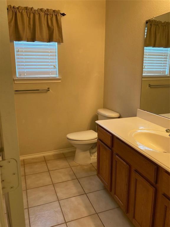 717 Mahogany Drive Anna, TX 75409 - Photo 7 of 11 a bathroom with a sink a toilet and a vanity