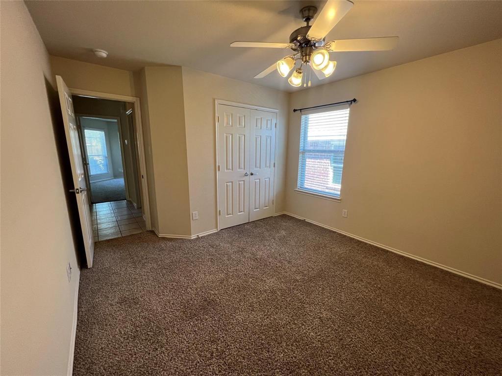 717 Mahogany Drive Anna, TX 75409 - Photo 8 of 11 an empty room with windows and fan