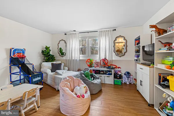 a living room with furniture a rug and a window