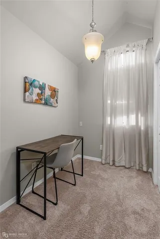 a view of a livingroom with furniture and chandelier fan