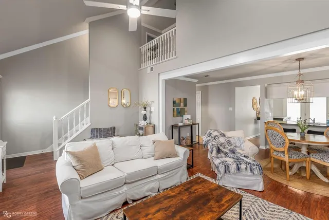 a living room with furniture and a chandelier