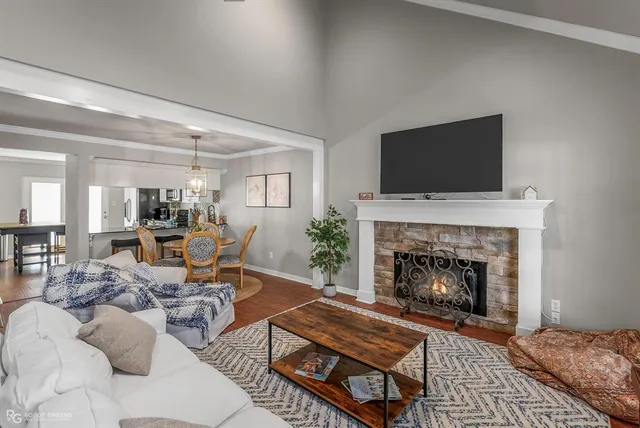 a living room with furniture a flat screen tv and a fireplace