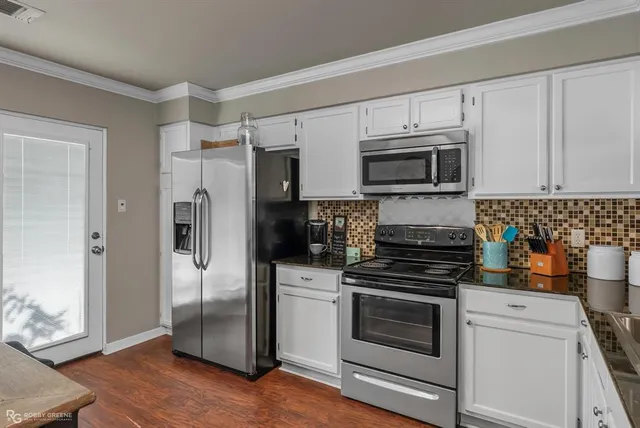 a kitchen with stainless steel appliances a stove a microwave and a refrigerator