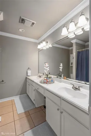 a bathroom with a sink vanity and mirror