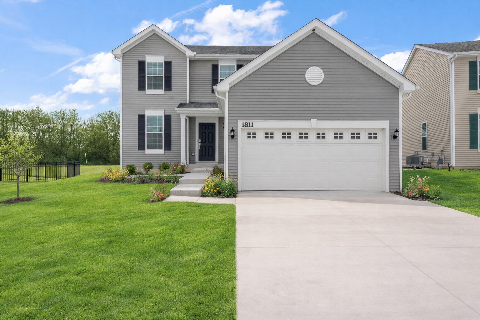 a front view of a house with a yard and garage