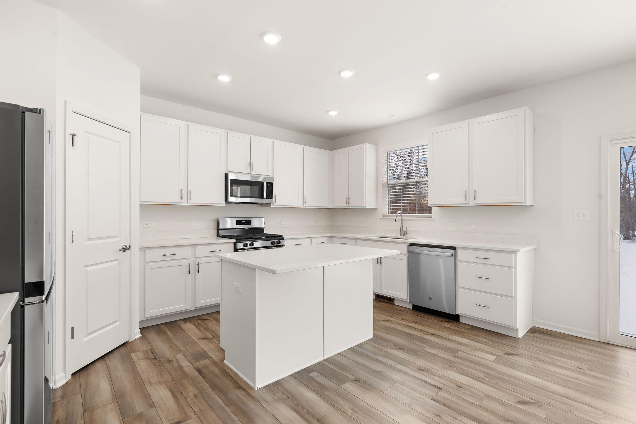 1811 East 111th Place Crown Point, IN 46307 - Photo 11 of 35 a kitchen with granite countertop white cabinets and white appliances