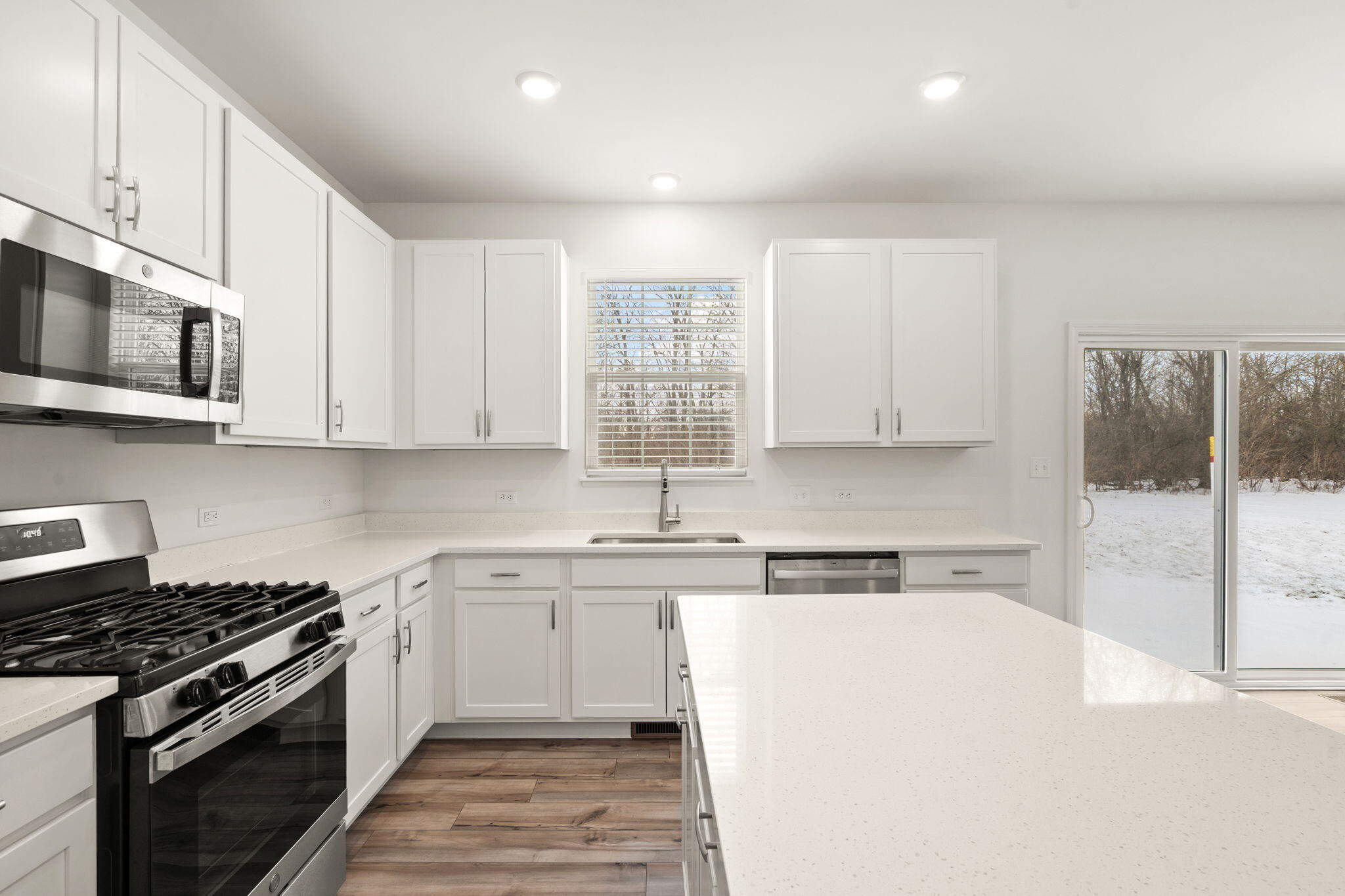 1811 East 111th Place Crown Point, IN 46307 - Photo 15 of 35 a kitchen with stainless steel appliances granite countertop a stove a sink and a microwave