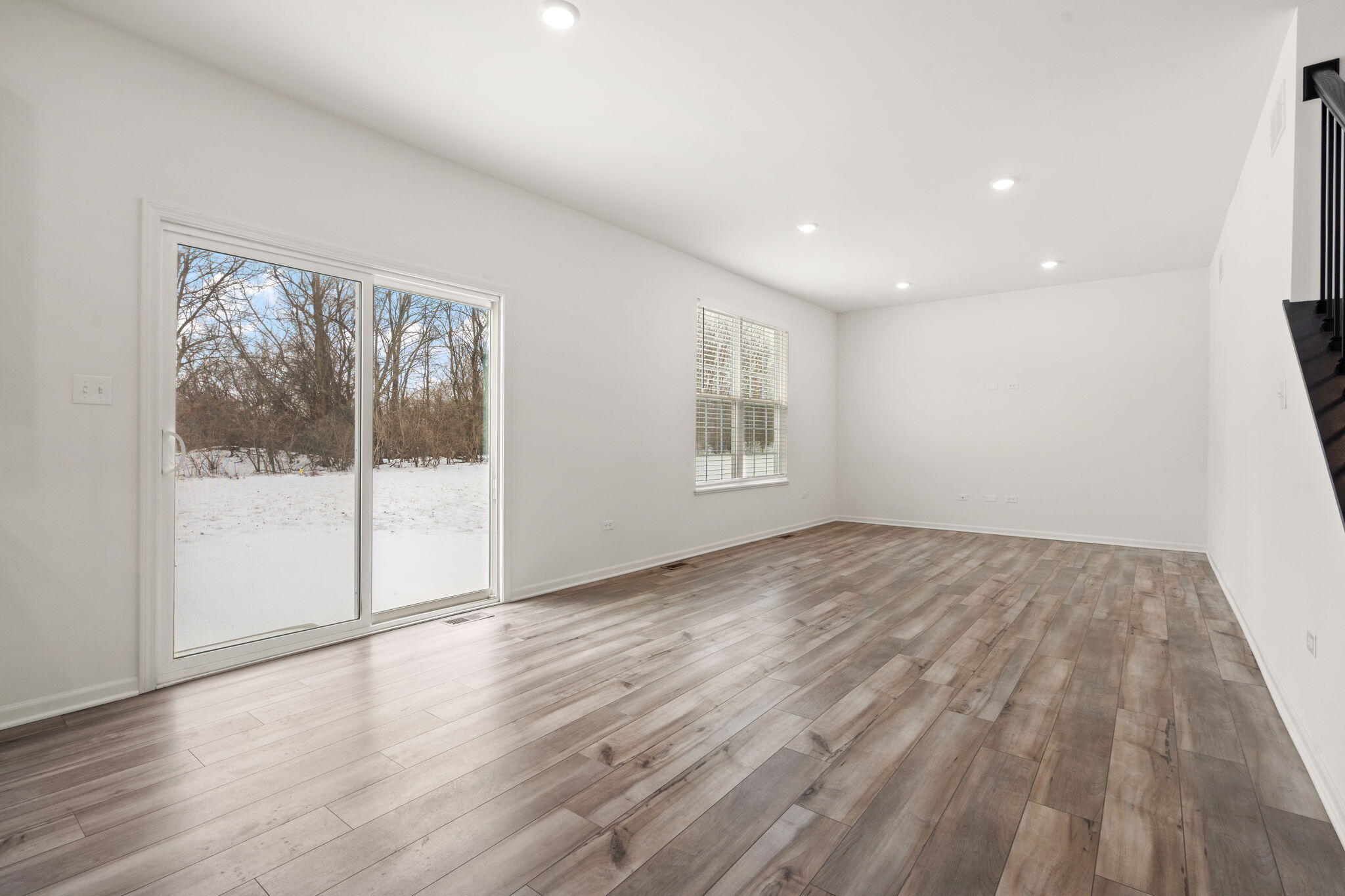 1811 East 111th Place Crown Point, IN 46307 - Photo 9 of 35 a view of empty room with wooden floor and fan