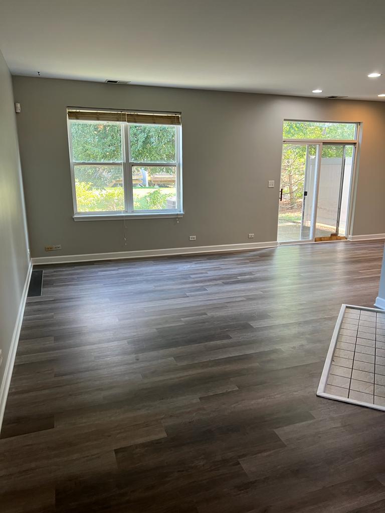 364 Risen Star Lane, Unit 364 Oswego, IL 60543 - Photo 11 of 15 an empty room with wooden floor and windows