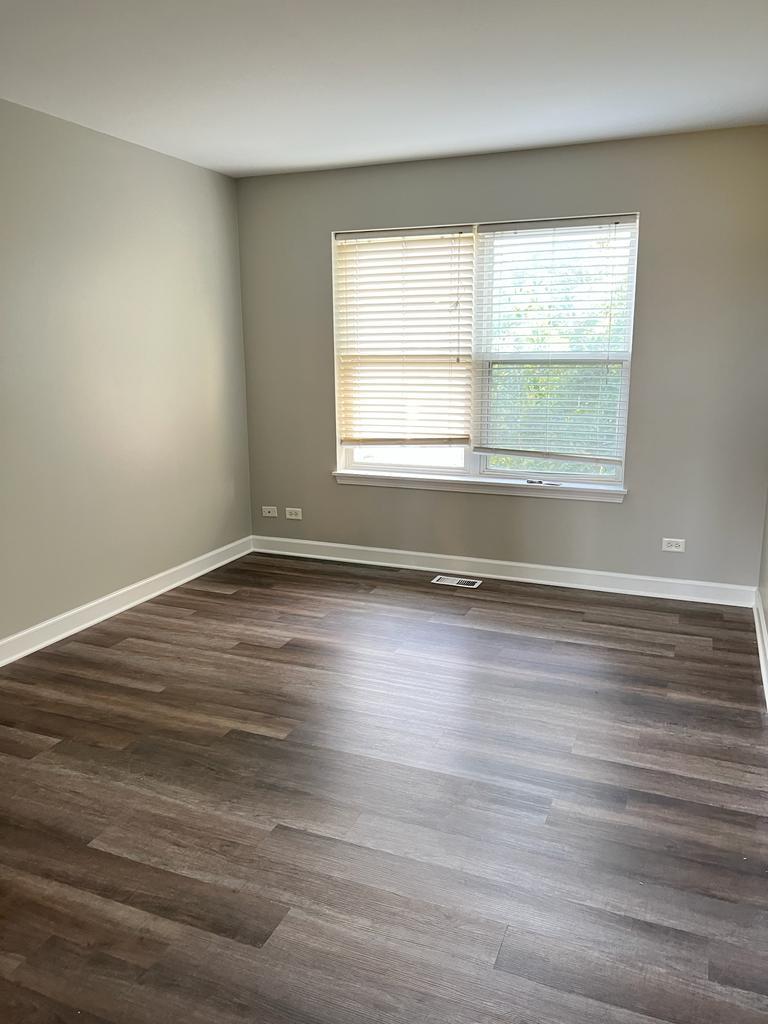 364 Risen Star Lane, Unit 364 Oswego, IL 60543 - Photo 6 of 15 wooden floor in an empty room with a window