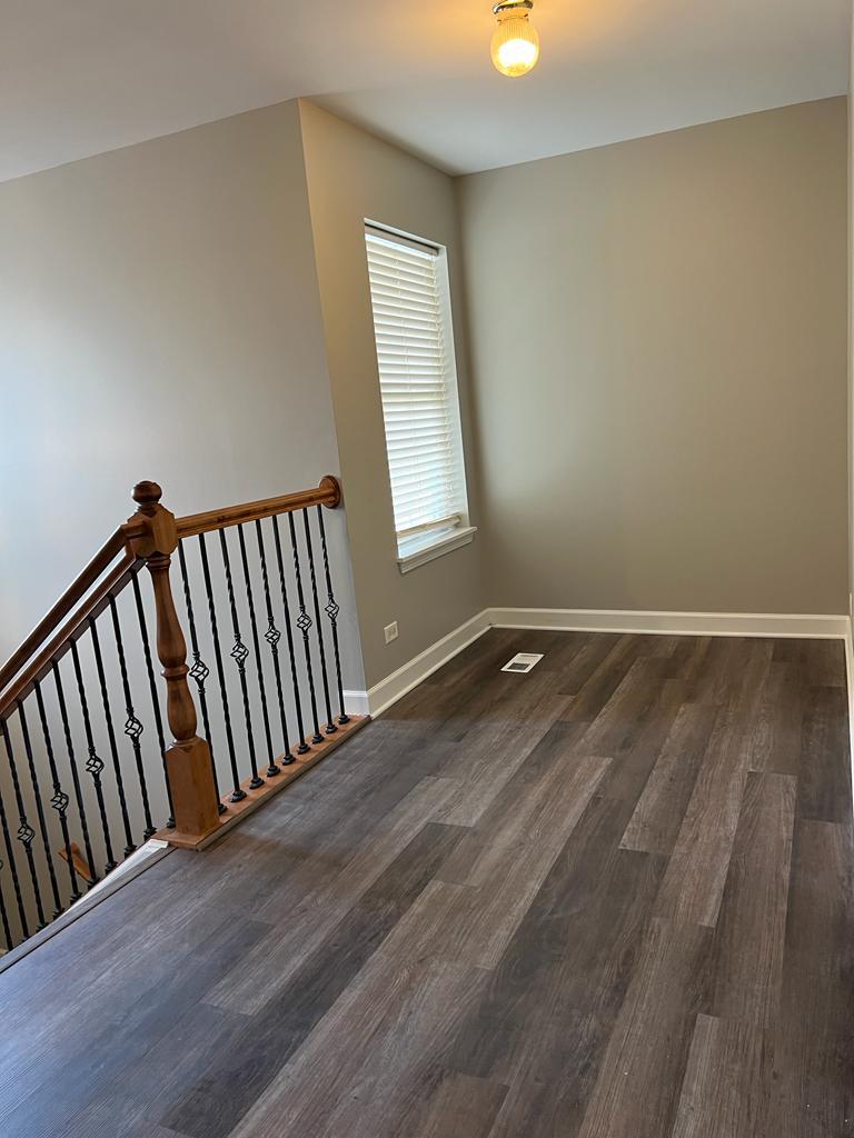 364 Risen Star Lane, Unit 364 Oswego, IL 60543 - Photo 7 of 15 a view of a hallway with wooden floor and window