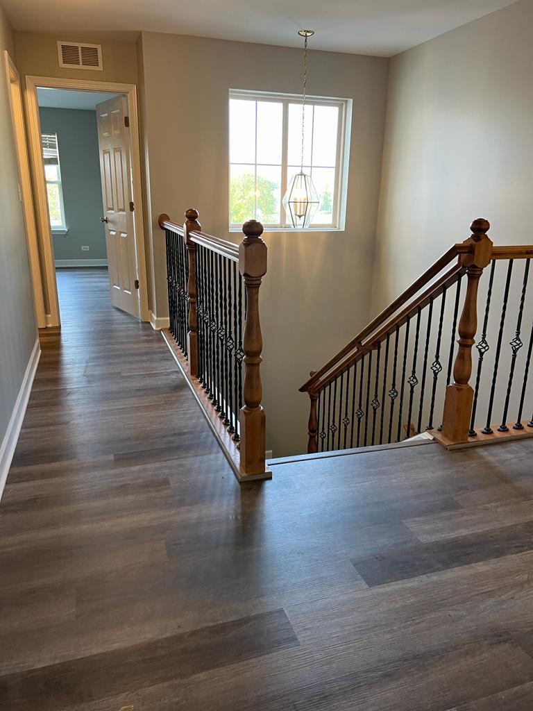 364 Risen Star Lane, Unit 364 Oswego, IL 60543 - Photo 8 of 15 a view of a hallway with wooden floor and windows