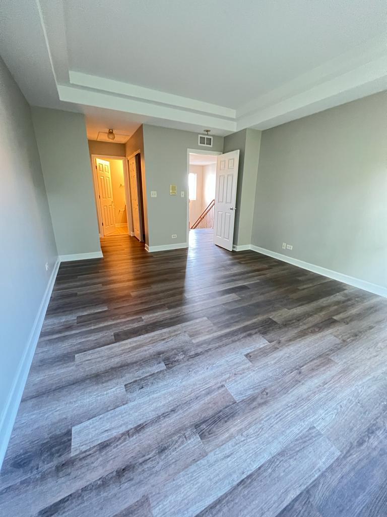 364 Risen Star Lane, Unit 364 Oswego, IL 60543 - Photo 10 of 15 a view of an empty room and wooden floor and a window