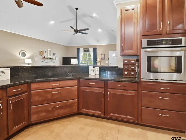 a kitchen with granite countertop cabinets and window