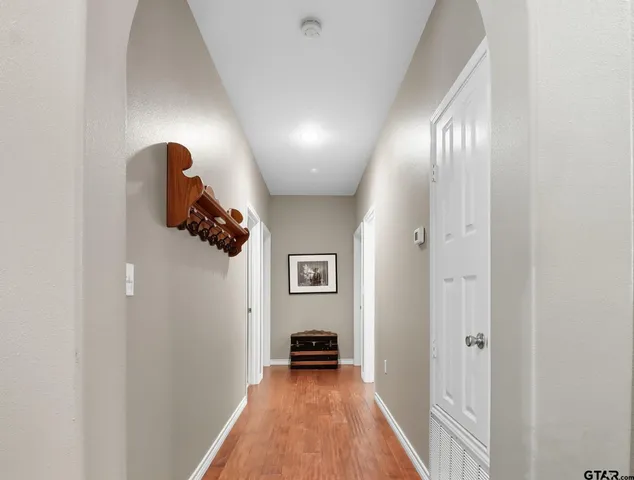 a view of a hallway with entryway wooden floor and front door