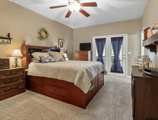 a spacious bedroom with a bed and a chandelier