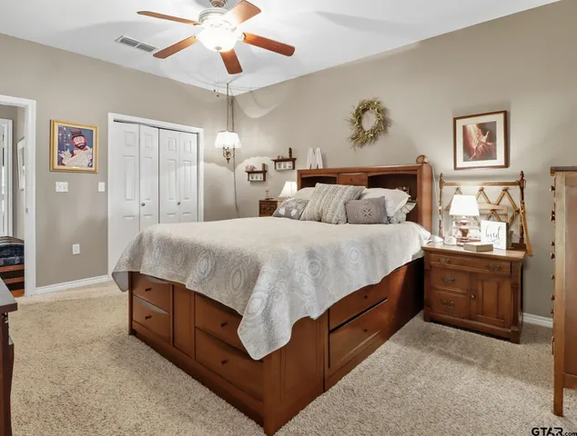 a spacious bedroom with a bed and a chandelier