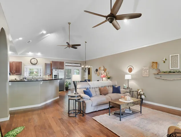 a living room with furniture and kitchen view