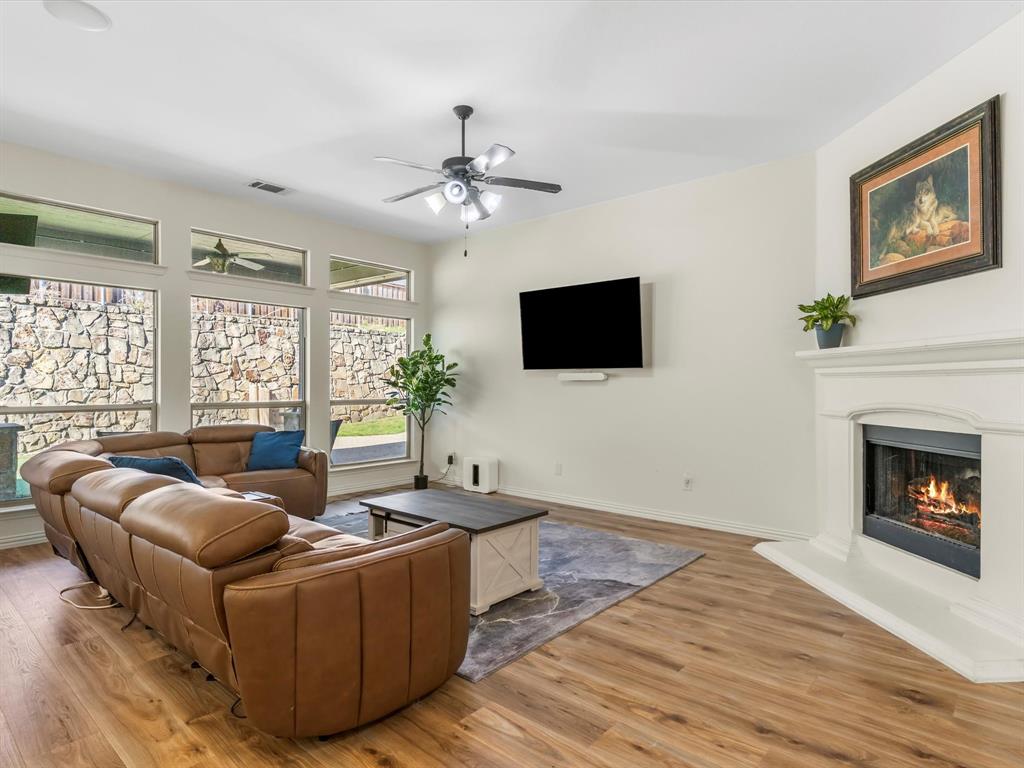 437 Hackworth Street Roanoke, TX 76262 - Photo 11 of 35 a living room with furniture a fireplace and a flat screen tv