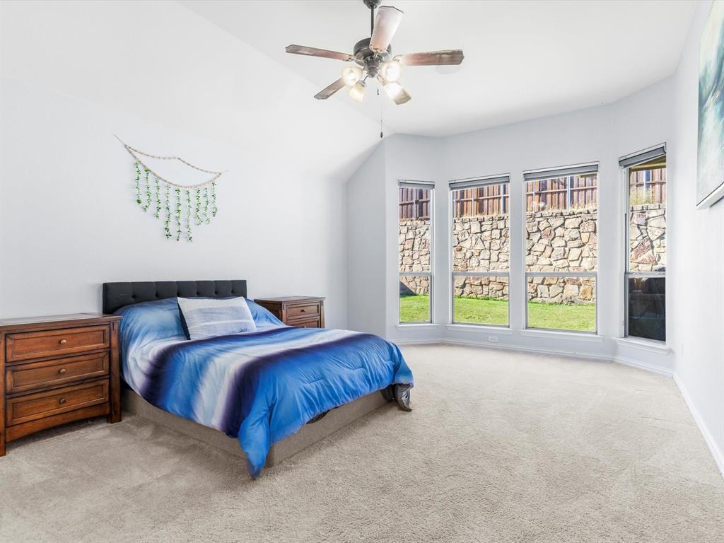437 Hackworth Street Roanoke, TX 76262 - Photo 16 of 35 a spacious bedroom with a bed and a large window