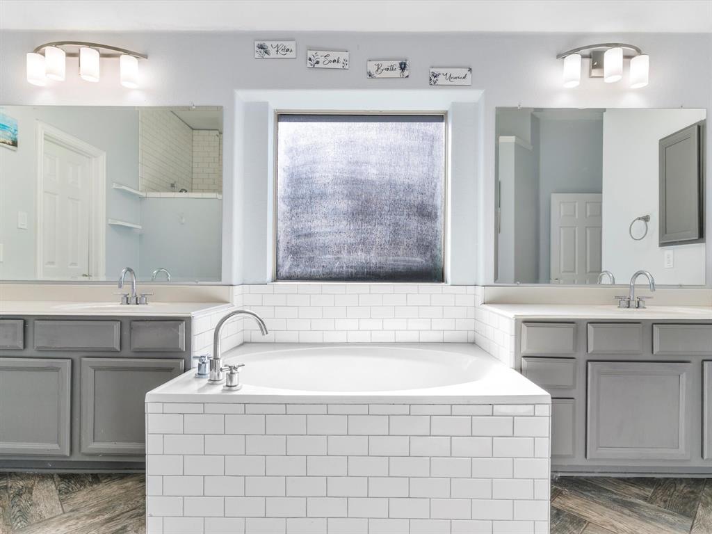 437 Hackworth Street Roanoke, TX 76262 - Photo 21 of 35 a bathroom with a double vanity sink mirror and bathtub