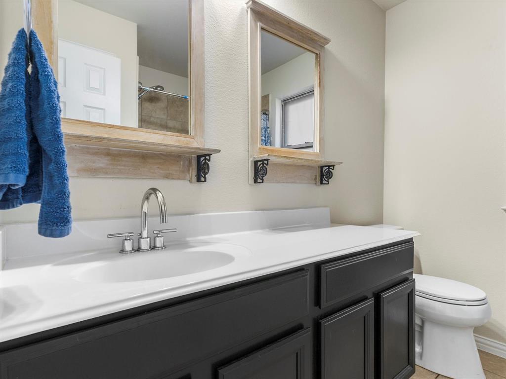 437 Hackworth Street Roanoke, TX 76262 - Photo 23 of 35 a bathroom with a sink and a toilet