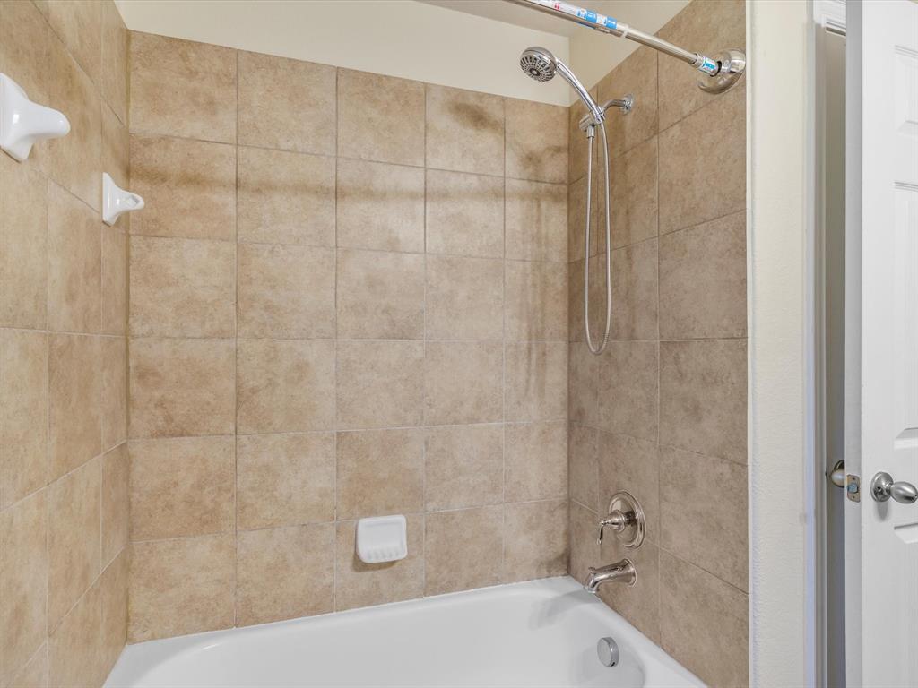 437 Hackworth Street Roanoke, TX 76262 - Photo 24 of 35 a bathroom with a bathtub and shower