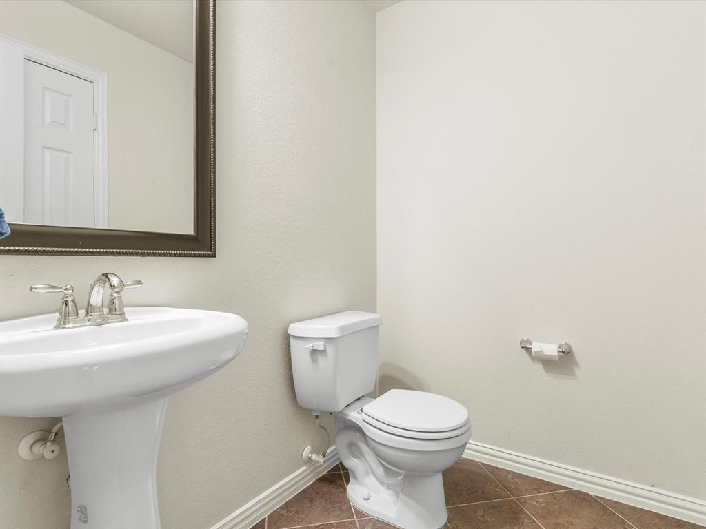 437 Hackworth Street Roanoke, TX 76262 - Photo 27 of 35 a bathroom with a toilet sink and mirror