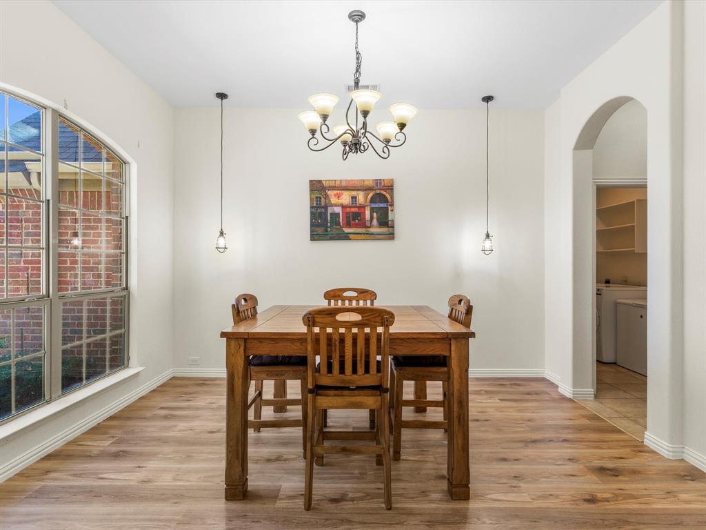 437 Hackworth Street Roanoke, TX 76262 - Photo 8 of 35 a view of a dining room with furniture wooden floor and a chandelier
