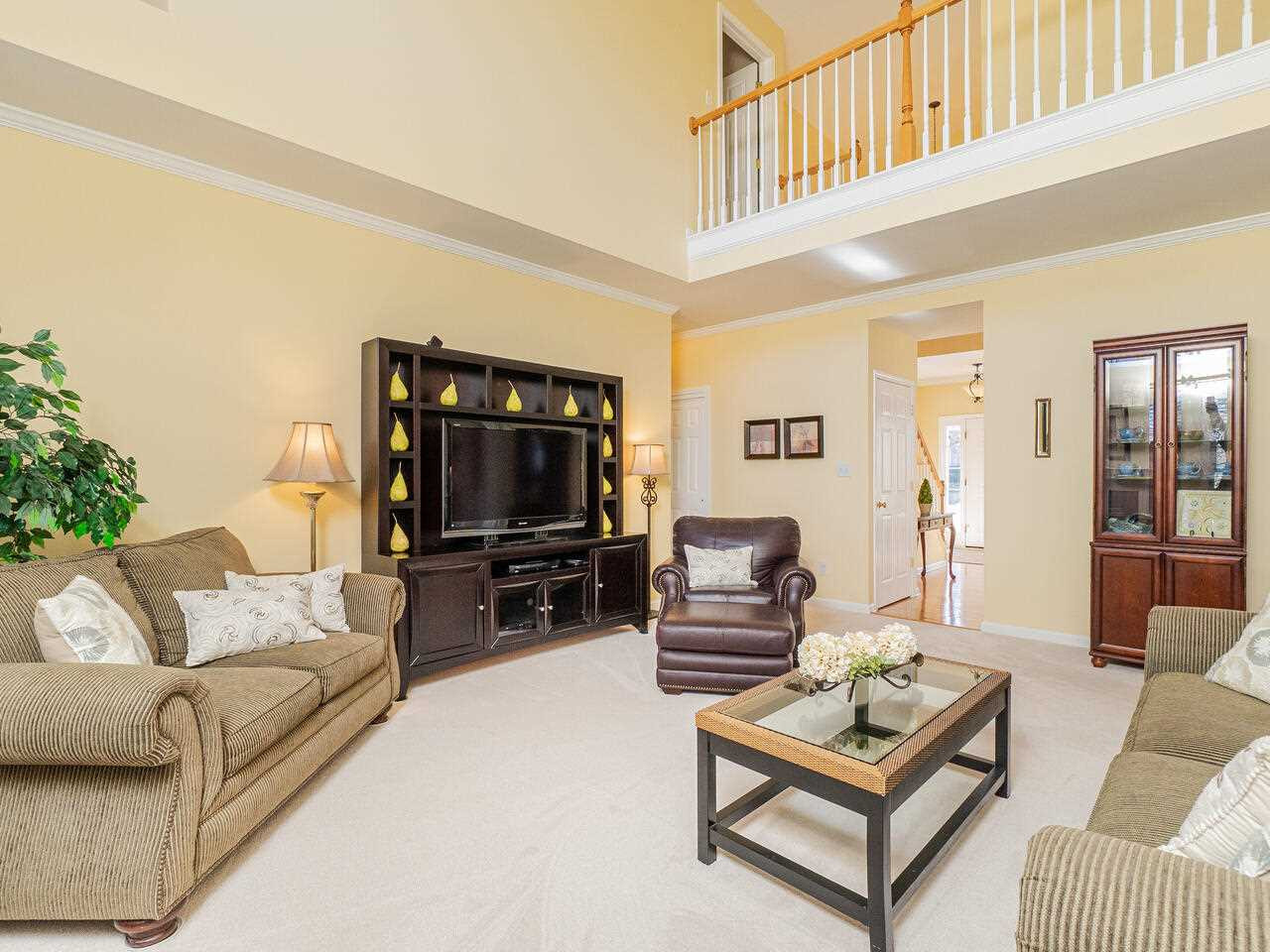426 Seastone Street Raleigh, NC 27603 - Photo 11 of 30 a living room with furniture and a flat screen tv