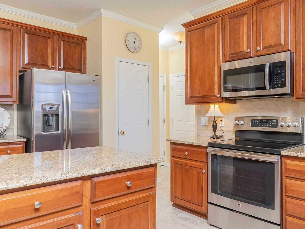 426 Seastone Street Raleigh, NC 27603 - Photo 14 of 30 a kitchen with granite countertop cabinets stainless steel appliances and a counter space