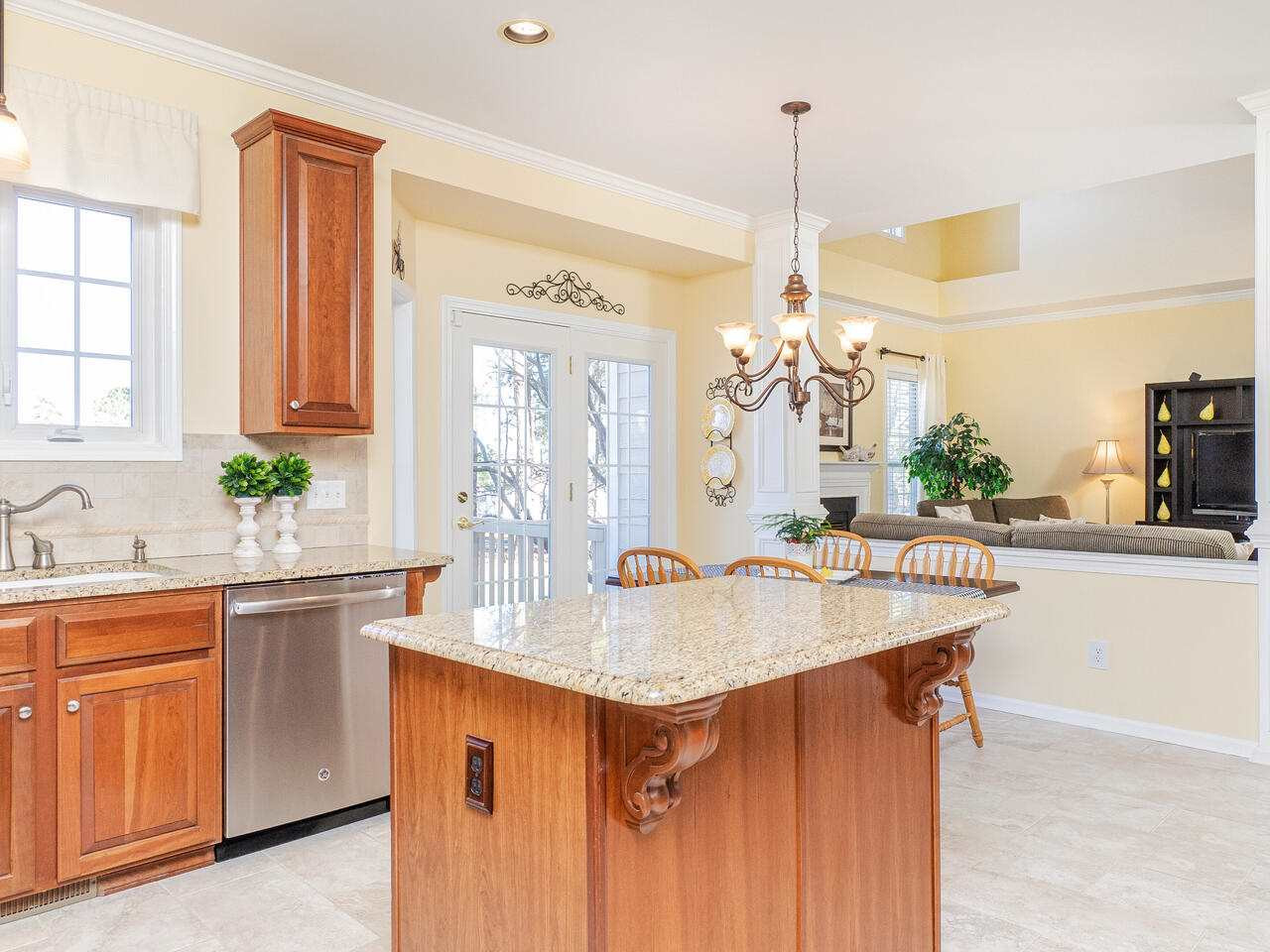 426 Seastone Street Raleigh, NC 27603 - Photo 15 of 30 a dining hall with granite countertop a sink dishwasher a stove and a dining table with wooden floor