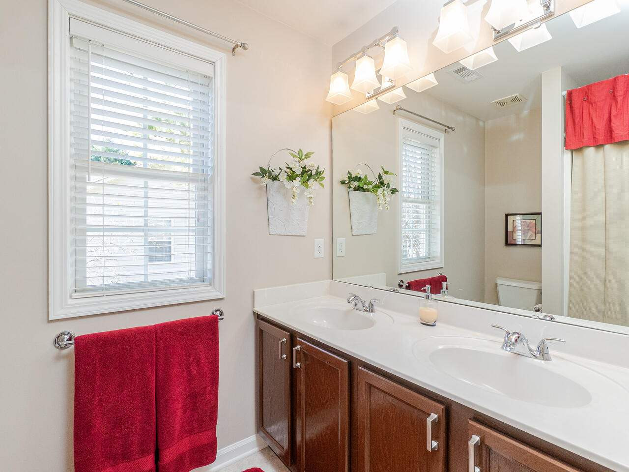 426 Seastone Street Raleigh, NC 27603 - Photo 22 of 30 a bathroom with a sink vanity tub and a mirror
