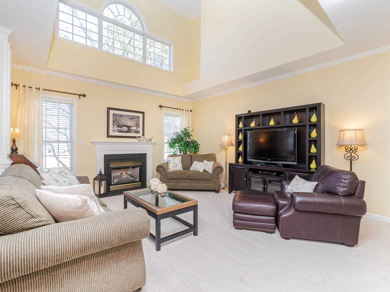 426 Seastone Street Raleigh, NC 27603 - Photo 10 of 30 a living room with furniture a flat screen tv and a fireplace