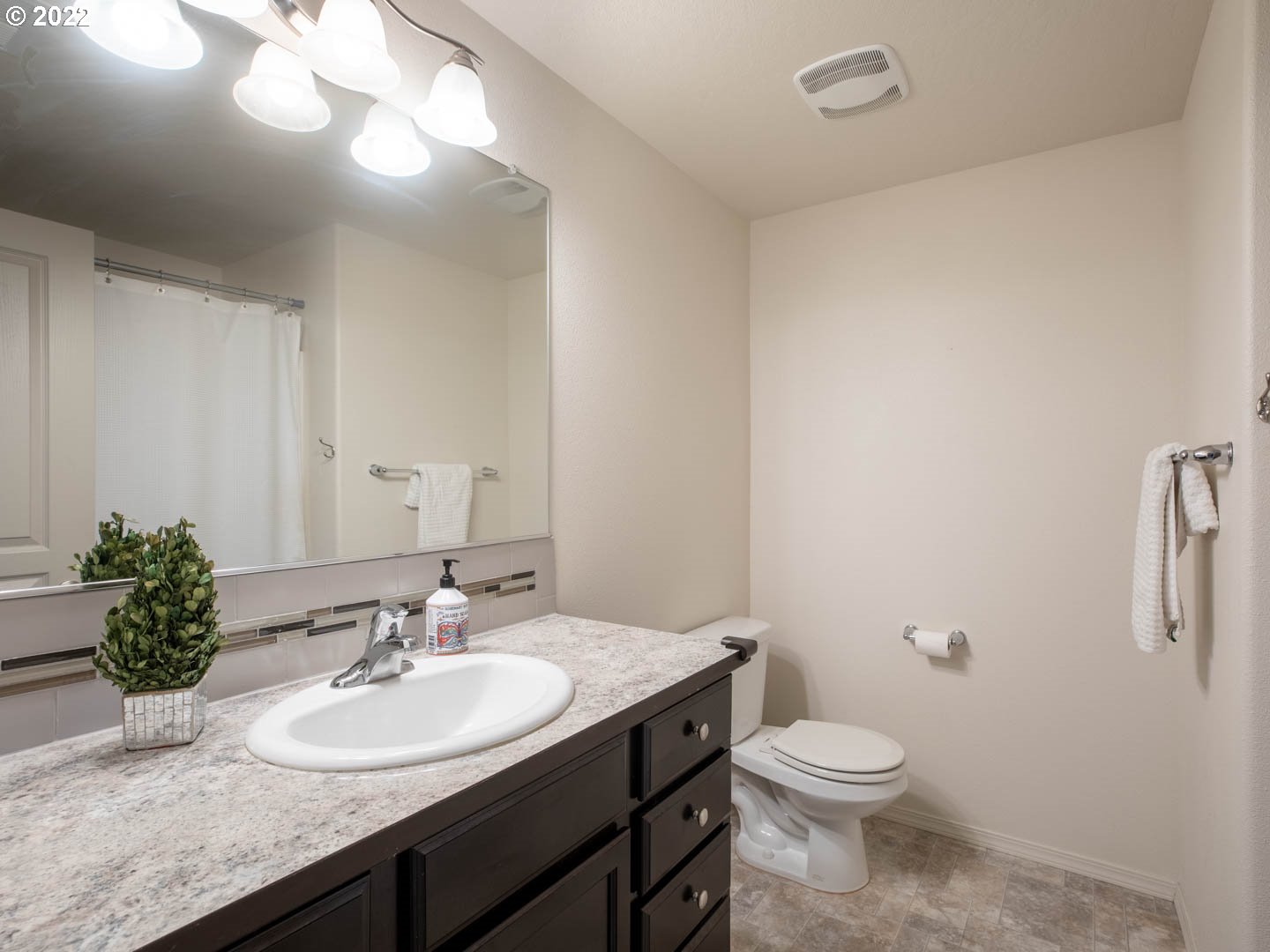 4664 Rocky Road Springfield, OR 97478 - Photo 16 of 21 a bathroom with a granite countertop sink a toilet and a mirror