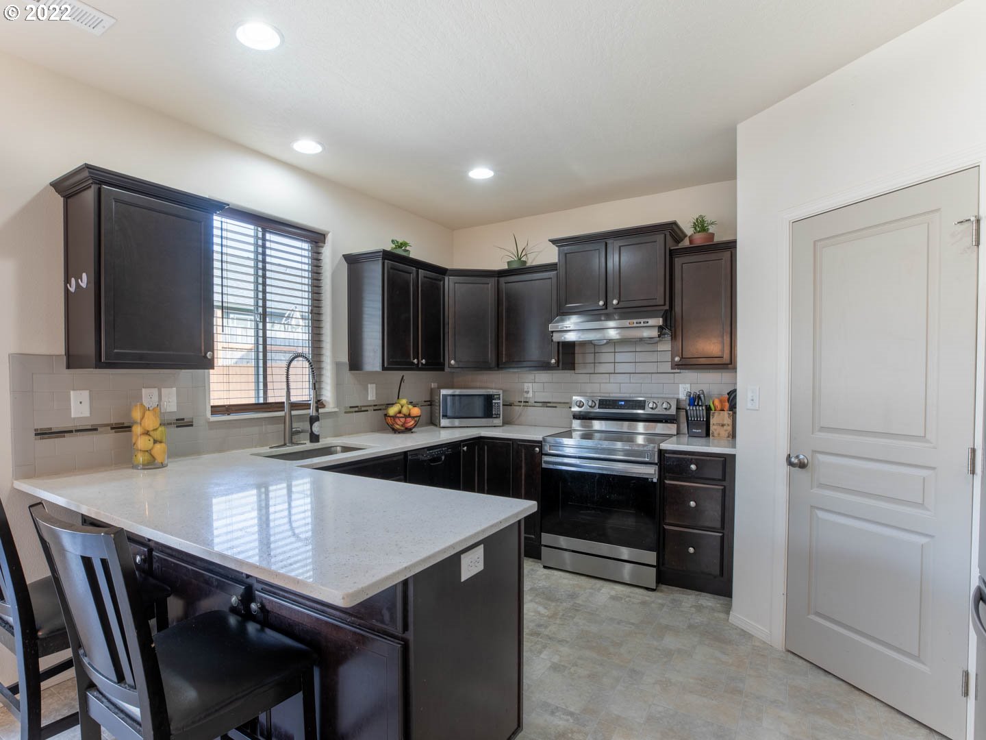 4664 Rocky Road Springfield, OR 97478 - Photo 6 of 21 a kitchen with kitchen island a sink stove and microwave
