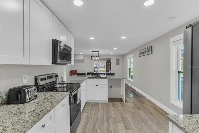 a kitchen with a sink stove and refrigerator