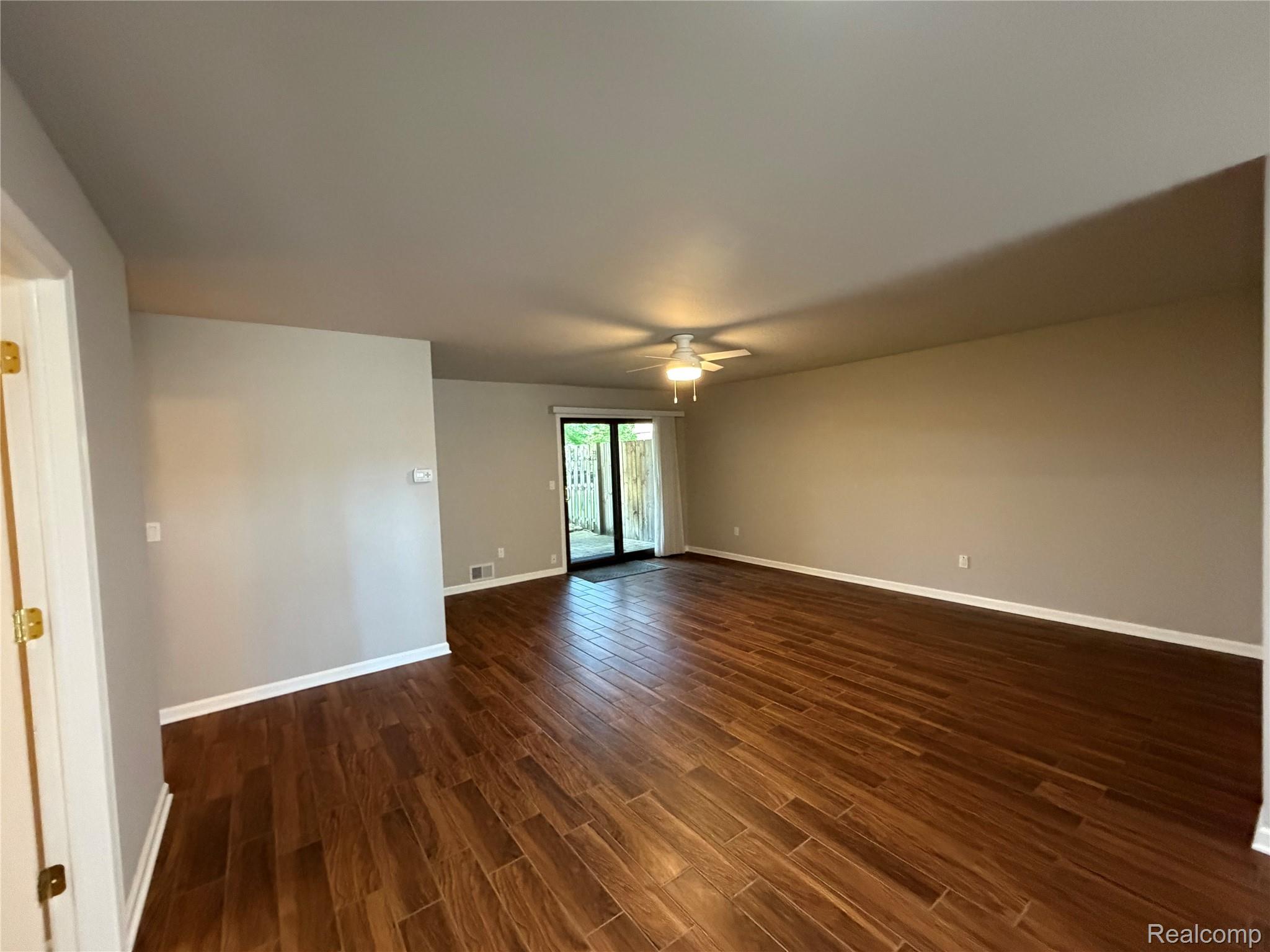 5220 West Utica Road Utica, MI 48317 - Photo 7 of 24 Open living area featuring wood-finish flooring and neutral wall tones