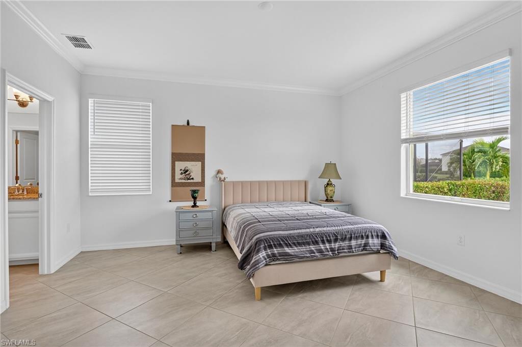 2126 Hamlin Street Naples, FL 34120 - Photo 10 of 38 a bedroom with a bed and a window